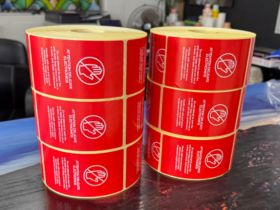 Rolls of red Attention Delicate Electronics anti-static warning labels